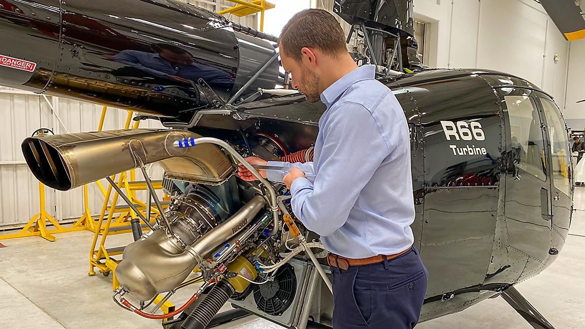 robinson helicopter design engineer checks engine tolerances